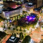 Aerial view of a vibrant outdoor concert in downtown Chattanooga at night.