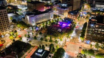 Aerial view of a vibrant outdoor concert in downtown Chattanooga at night.