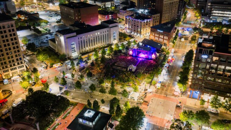 Aerial view of a vibrant outdoor concert in downtown Chattanooga at night.