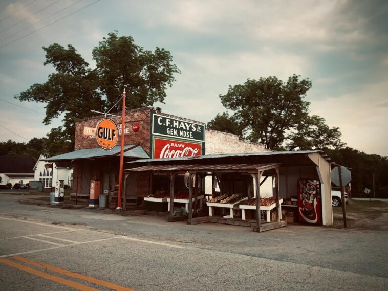 Charming small-town Georgia storefront with vintage signs and rustic appeal.