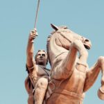 Majestic statue of a warrior on horseback in Skopje, symbolizing strength and history.