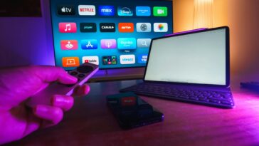 A cozy home setup featuring streaming services on smart TV, tablet, and smartphone.