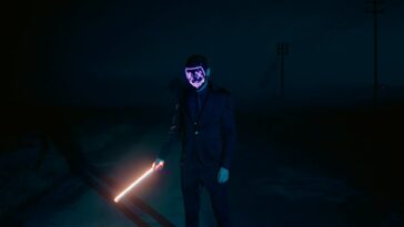 Dark night scene of a mysterious figure in a glowing mask holding a light sword.