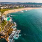 Stunning aerial view of Bondi Beach in Sydney, showcasing vibrant turquoise waters and sandy shores.