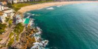 Stunning aerial view of Bondi Beach in Sydney, showcasing vibrant turquoise waters and sandy shores.