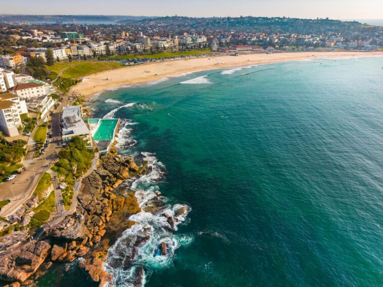 Stunning aerial view of Bondi Beach in Sydney, showcasing vibrant turquoise waters and sandy shores.