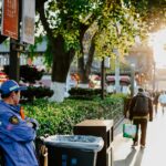 A vibrant street scene in Nanjing, China during fall, showcasing daily urban life.