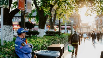 A vibrant street scene in Nanjing, China during fall, showcasing daily urban life.