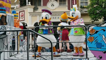 Vibrant Disney characters in a parade at Disneyland Paris, capturing festive spirit.