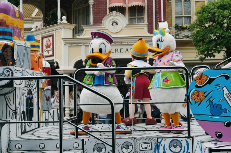 Vibrant Disney characters in a parade at Disneyland Paris, capturing festive spirit.