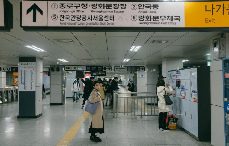 Busy day at a Seoul subway station with commuters navigating their way.