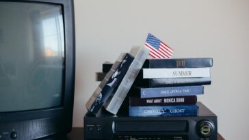 A nostalgic scene with VHS tapes, a vintage TV, and a small American flag.