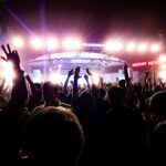 Energetic crowd enjoying a live concert under bright stage lights in Guwahati, India.