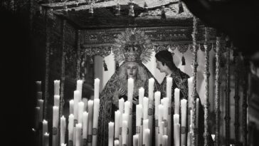 Black and white image of a religious altar with statues and candles in Carmona, Spain.
