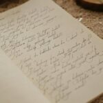 Beautiful close-up of handwritten calligraphy on vintage paper with delicate patterns.