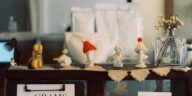 A cozy display of handcrafted figurines on a café shelf with vintage charm.