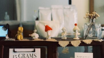 A cozy display of handcrafted figurines on a café shelf with vintage charm.