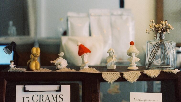 A cozy display of handcrafted figurines on a café shelf with vintage charm.