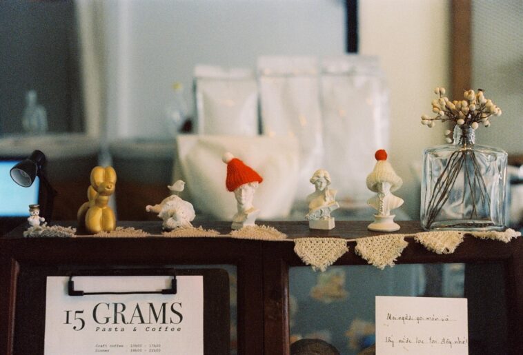 A cozy display of handcrafted figurines on a café shelf with vintage charm.