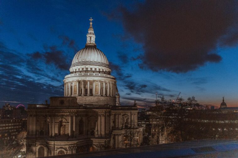 Beautiful nighttime cityscape featuring St. Paul's Cathedral in London with an illuminated skyline.