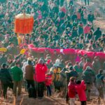 A vibrant traditional festival featuring a lively dragon dance procession outdoors.