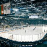 Exciting ice hockey game with players and crowd in a vibrant indoor arena atmosphere.