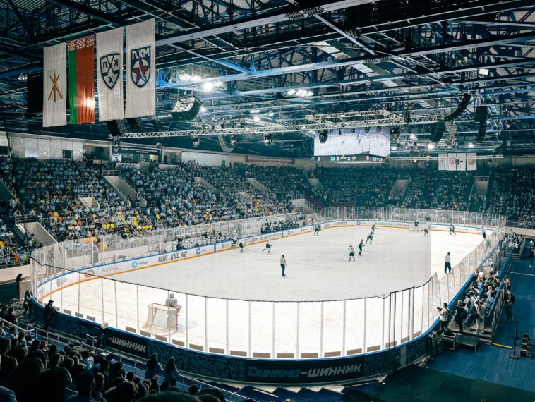 Exciting ice hockey game with players and crowd in a vibrant indoor arena atmosphere.