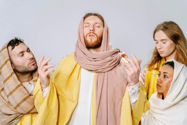 Four individuals portray biblical figures in traditional attire, emphasizing spirituality and role play.
