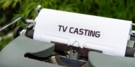 Close-up of a vintage typewriter with a sheet saying 'TV Casting', emphasizing the concept of scriptwriting.