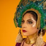 Close-up portrait of a woman wearing a traditional kokoshnik headdress on a vibrant yellow background.