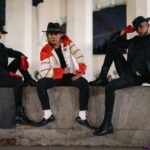 Three people in Michael Jackson-inspired outfits pose confidently at night in Mexico City.