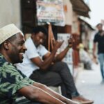 Casual street scene in Zanzibar City with men enjoying the day. Capturing vibrant street life and culture.