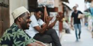 Casual street scene in Zanzibar City with men enjoying the day. Capturing vibrant street life and culture.