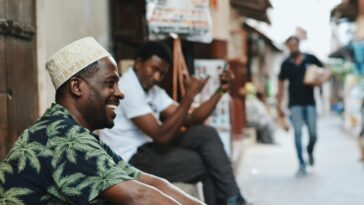 Casual street scene in Zanzibar City with men enjoying the day. Capturing vibrant street life and culture.